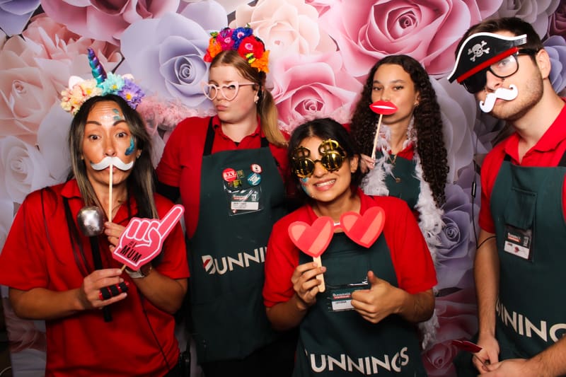 Employees enjoying Perth photo booth fun at office party